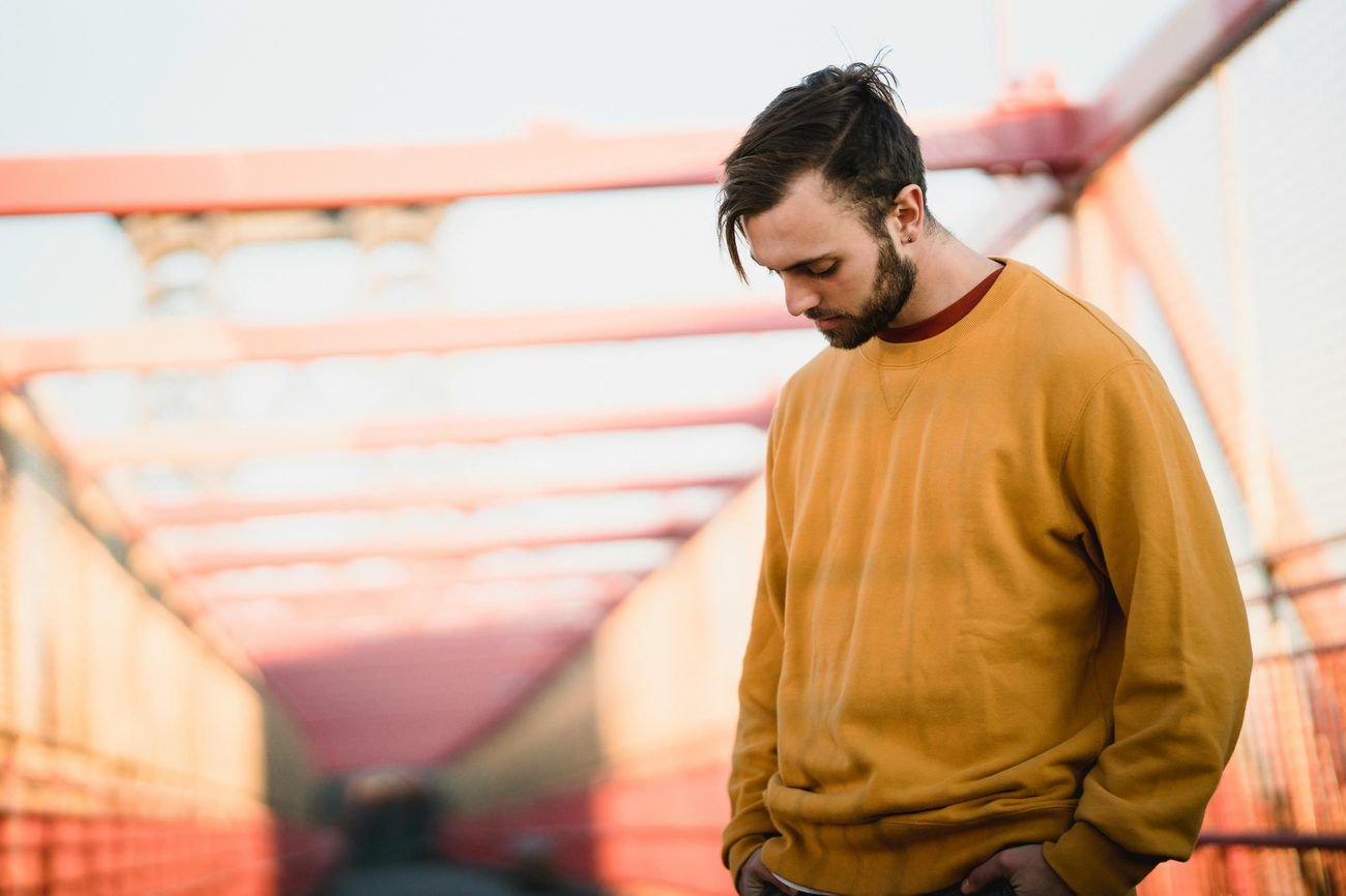 Man pausing in thought, representing how men often delay urological care